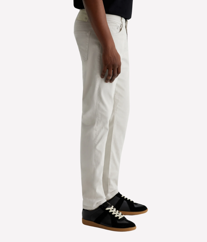 Men’s slim-fit five-pocket pants in an ultra-pale grey, crafted from soft and lightweight Italian Sueded Stretch Sateen. Features a mid-rise waist, fitted upper block, and tapered leg for a modern, polished look.