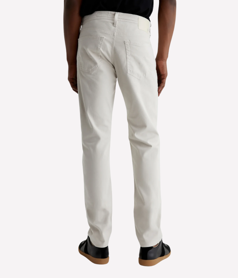 Men’s slim-fit five-pocket pants in an ultra-pale grey, crafted from soft and lightweight Italian Sueded Stretch Sateen. Features a mid-rise waist, fitted upper block, and tapered leg for a modern, polished look.