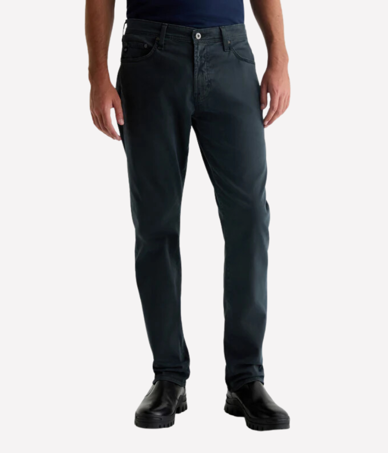 AG's Everett slim-straight men's pants in dark grey, crafted from 8.4 oz. Sueded Stretch Sateen from Italy. Featuring a mid-rise waist and a straight fit relaxed from hip to knee with a slight taper at the leg opening. Detailed measurements include a 10 1/4" front rise, 16 1/2" knee opening, 15" bottom opening, and 34" inseam.