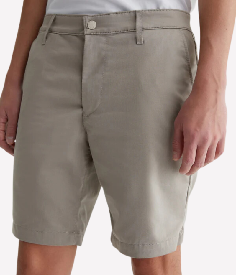 Front view of AG Wanderer Shorts in Dry Dust, showcasing the slim fit, light khaki shade, and clean trouser-style design.