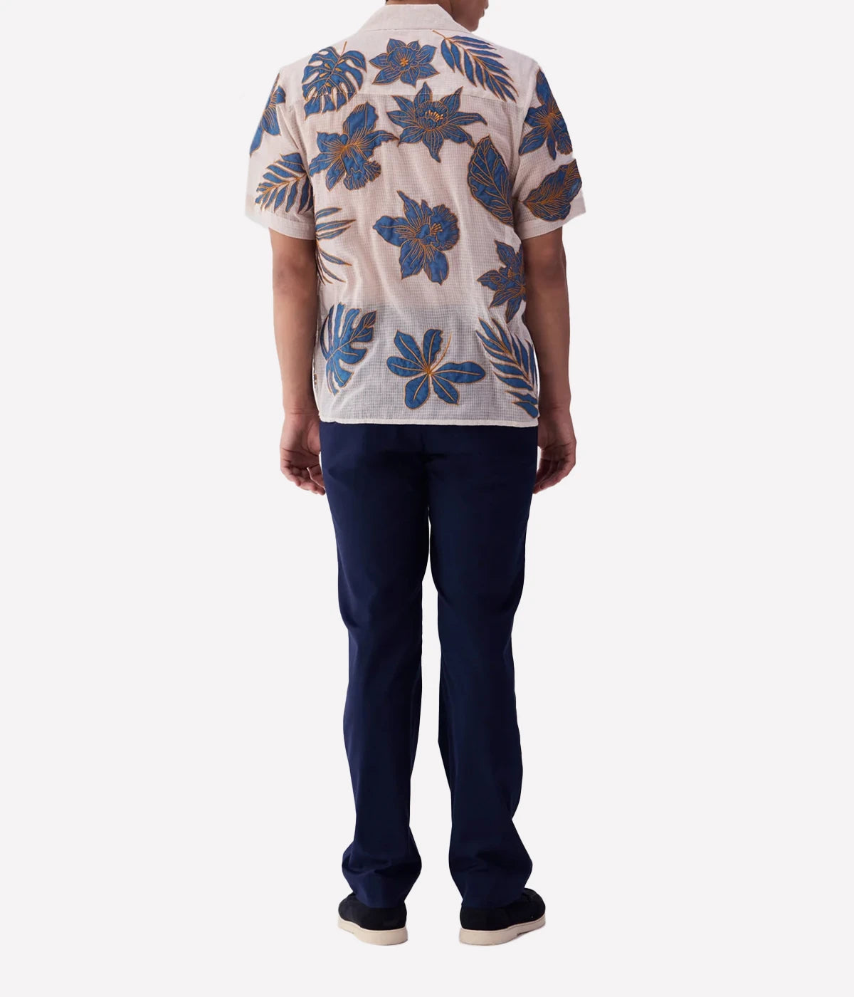 Perte D’ego Blue Floral Appliqué Shirt made from sheer, lightweight cotton mesh, featuring hand-embroidered floral appliqué detailing on the front. Relaxed fit, short sleeves, and a breezy design, perfect for beachside styling or warm-weather occasions.