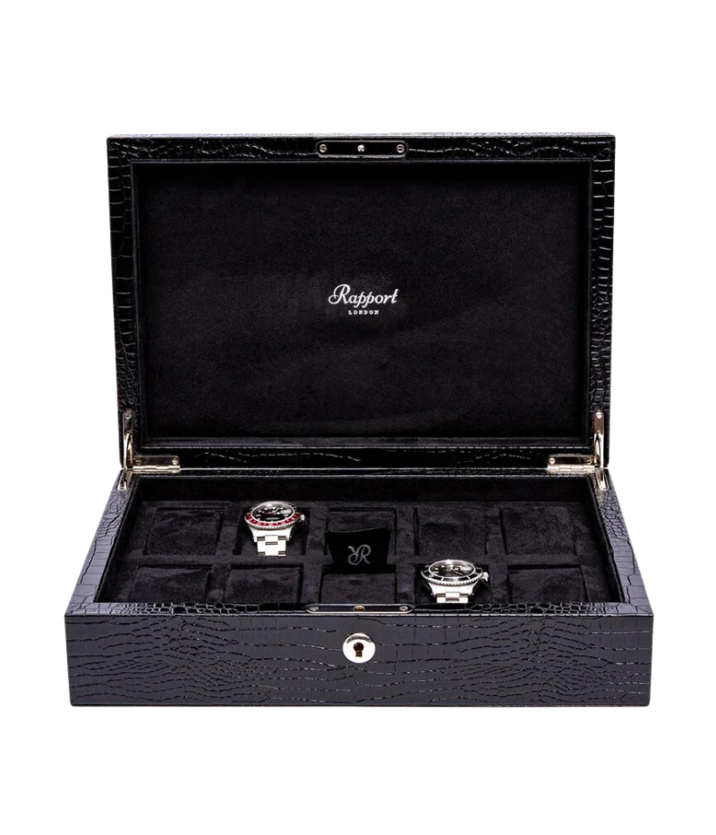 The Brompton Watch Box is meticulously handcrafted from solid wood and wrapped in luxurious black crocodile-pattern leather. Designed to hold up to ten watches, it features a plush suede-lined interior and adjustable cushions to securely fit timepieces of all sizes. A sophisticated storage solution for protecting and displaying your watch collection.