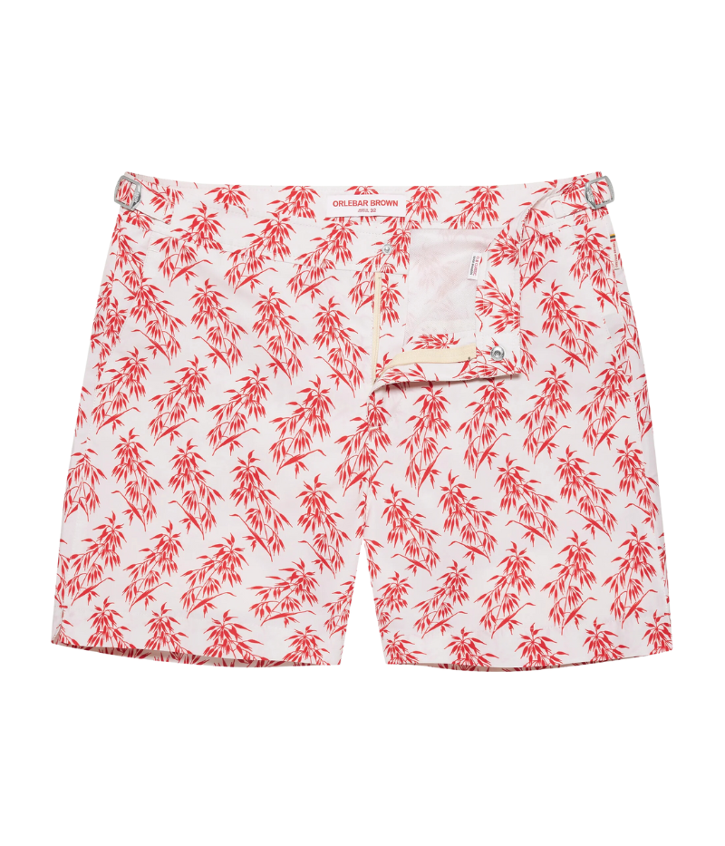 Bulldog Bamboo swim shorts by Orlebar Brown in Summer Red bamboo print on White Sand, made from quick-drying recycled polyester. Features signature Bulldog fit, adjustable branded nickel-effect side fasteners, and concealed snap closure.