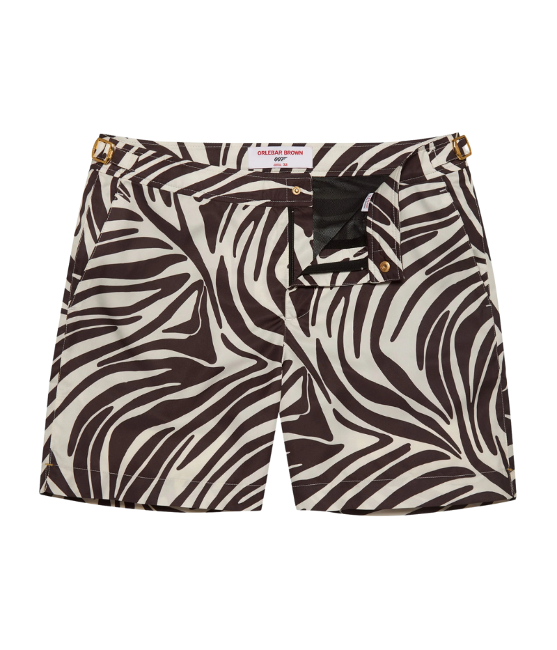 Front view of the Orlebar Brown Bulldog Golden Gun Zebra Swim Shorts in Truffle Latte, featuring an exclusive zebra print and gold-tone ‘007’ side adjusters for a tailored, adjustable fit.