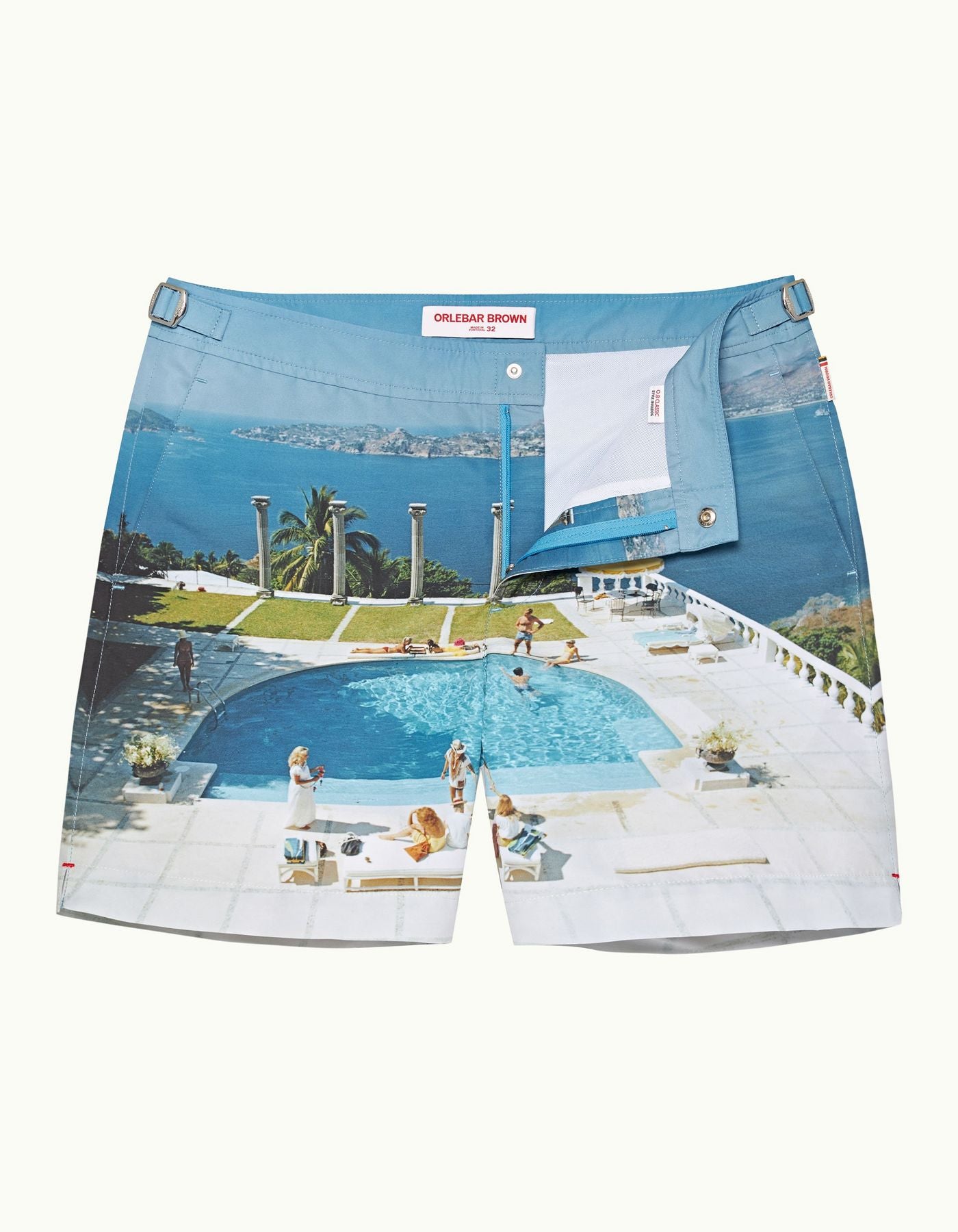 Orlebar Brown Bulldog Swim Shorts featuring a reworked Slim Aarons photograph of a glamorous poolside scene, perfect for adding a stylish statement to your holiday wardrobe.