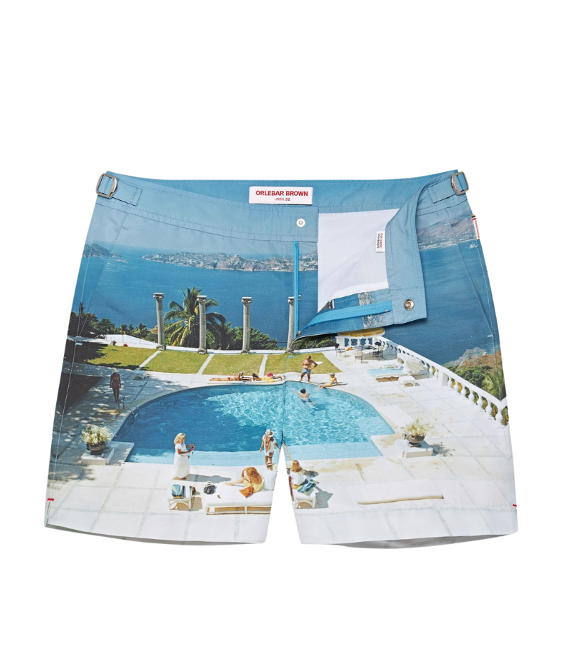 Orlebar Brown Bulldog Swim Shorts featuring a reworked Slim Aarons photograph of a glamorous poolside scene, perfect for adding a stylish statement to your holiday wardrobe.