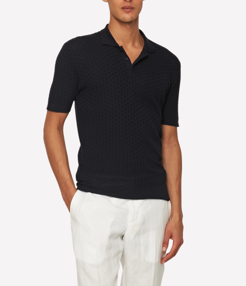 Burnham Italian knit polo shirt in dark navy with lattice pattern, crafted from a silk-cotton blend. Tailored fit, three-button placket, and hand-stitched O.B. detail near the hem.