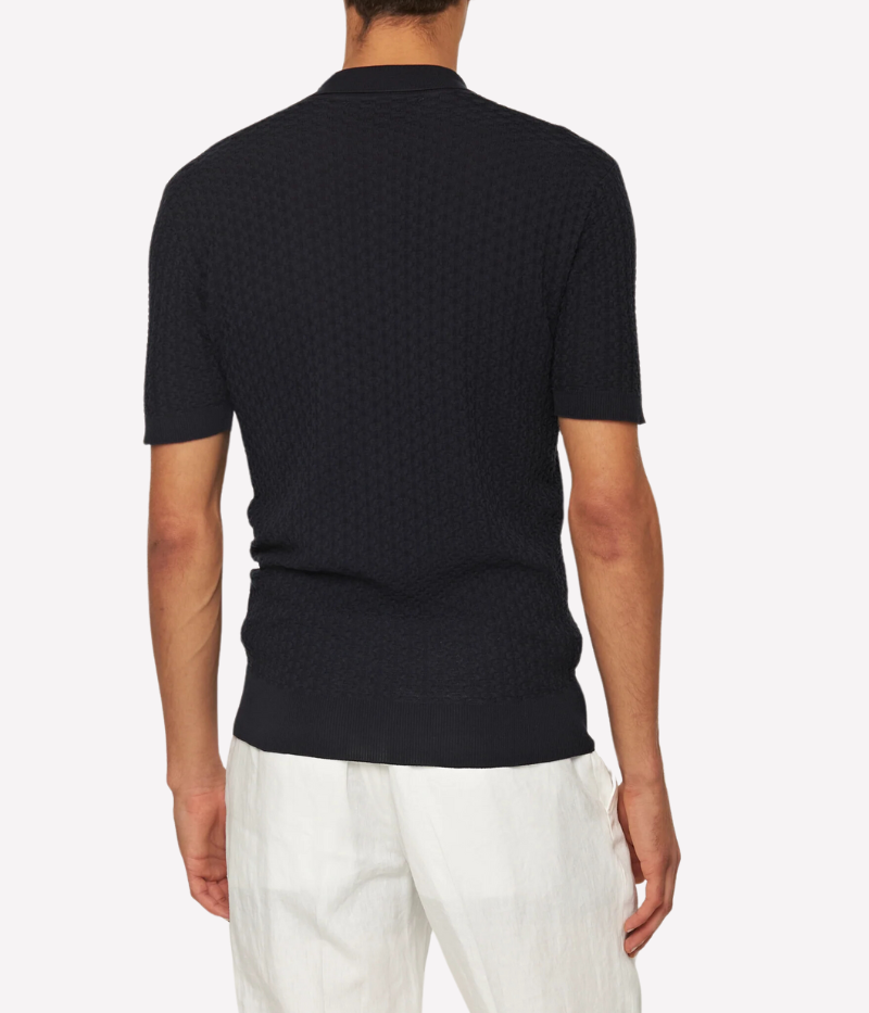 Burnham Italian knit polo shirt in dark navy with lattice pattern, crafted from a silk-cotton blend. Tailored fit, three-button placket, and hand-stitched O.B. detail near the hem.