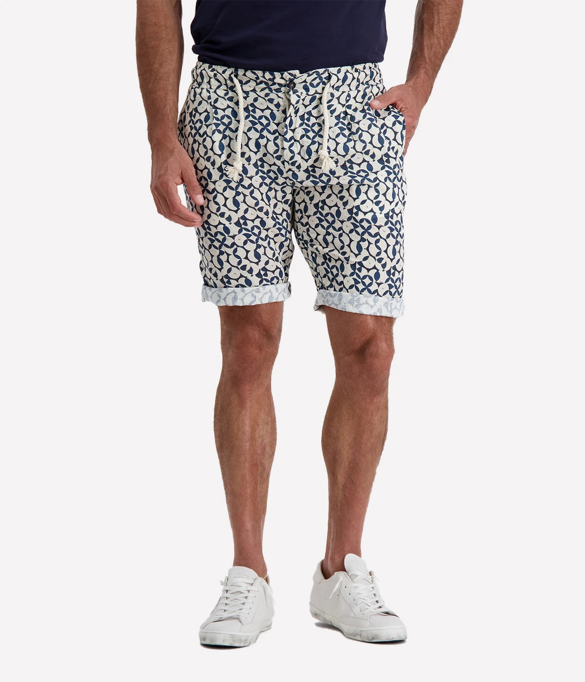 Navy and white patterned linen shorts with a rope drawstring and button closure, styled with a slight roll for a relaxed, effortless look. Breathable and lightweight, perfect for beach days or casual nights out.