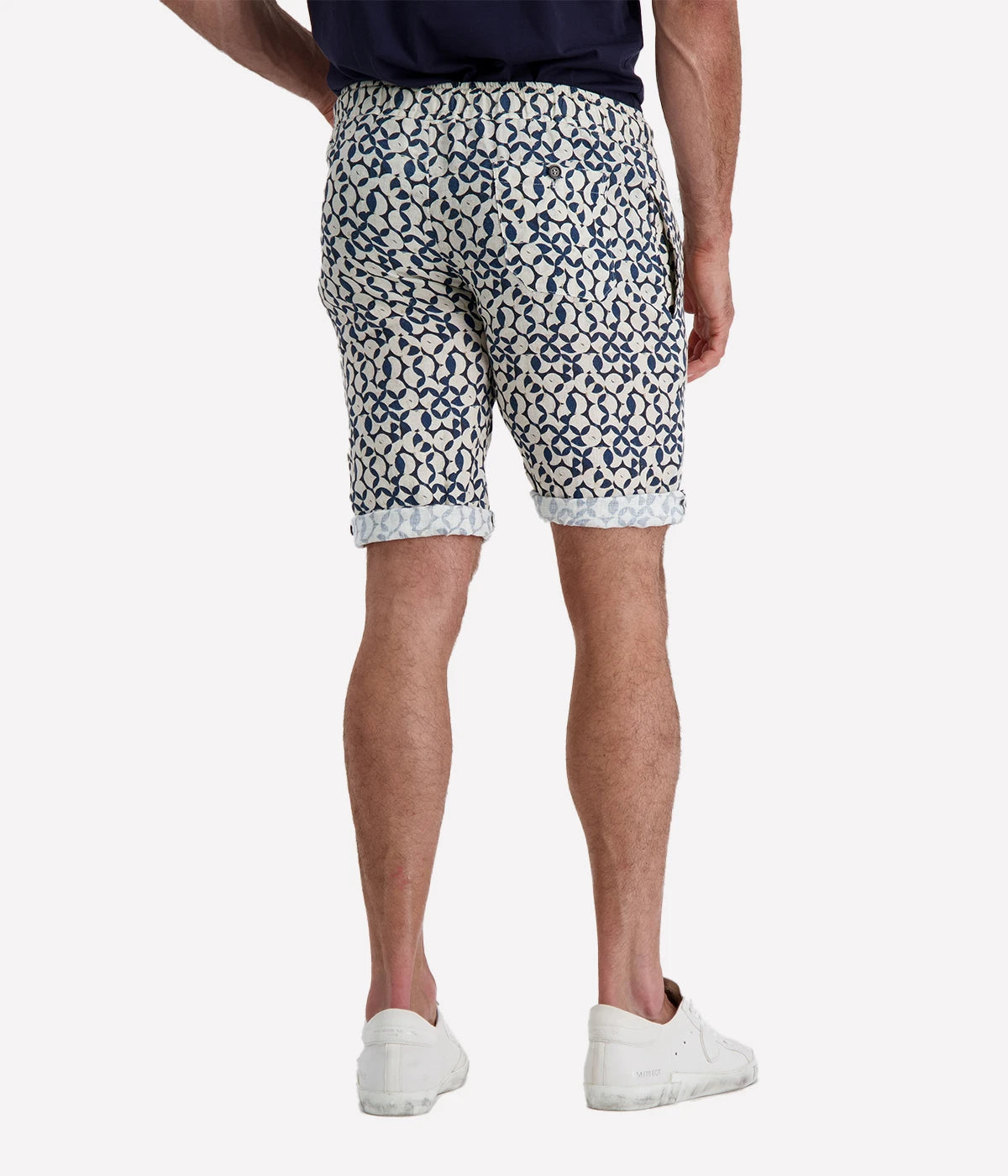 Navy and white patterned linen shorts with a rope drawstring and button closure, styled with a slight roll for a relaxed, effortless look. Breathable and lightweight, perfect for beach days or casual nights out.