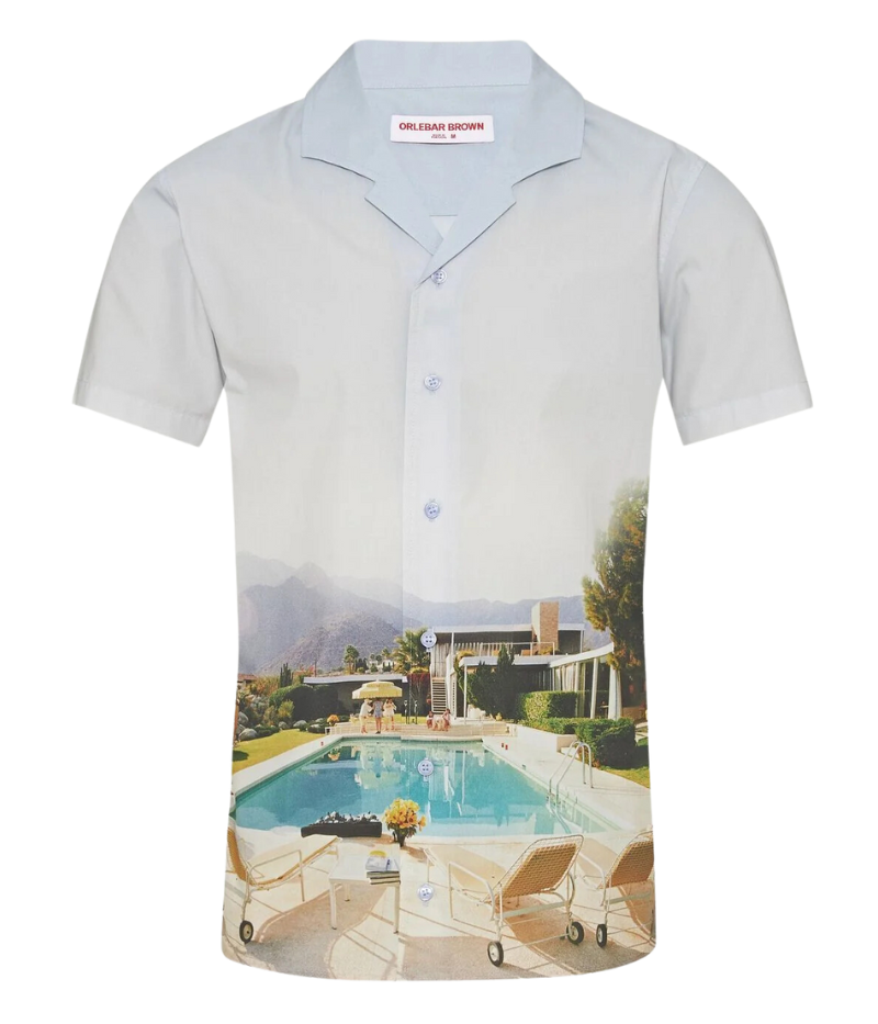 A classic-fit short-sleeve shirt featuring exclusive Slim Aarons artwork, a Capri collar, and imitation mother-of-pearl buttons, crafted from 100% organic cotton.