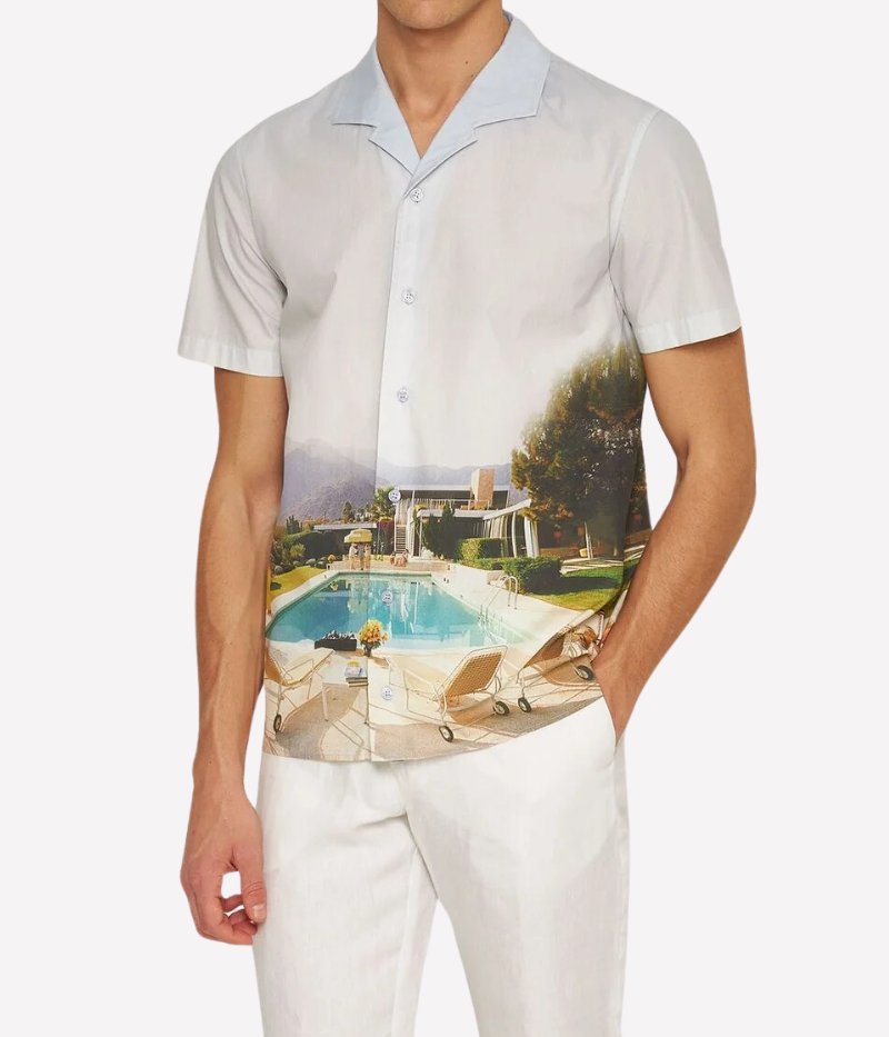 A classic-fit short-sleeve shirt featuring exclusive Slim Aarons artwork, a Capri collar, and imitation mother-of-pearl buttons, crafted from 100% organic cotton.