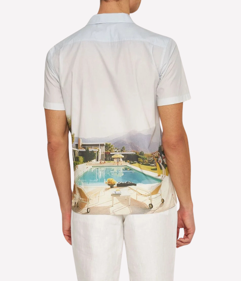 A classic-fit short-sleeve shirt featuring exclusive Slim Aarons artwork, a Capri collar, and imitation mother-of-pearl buttons, crafted from 100% organic cotton.