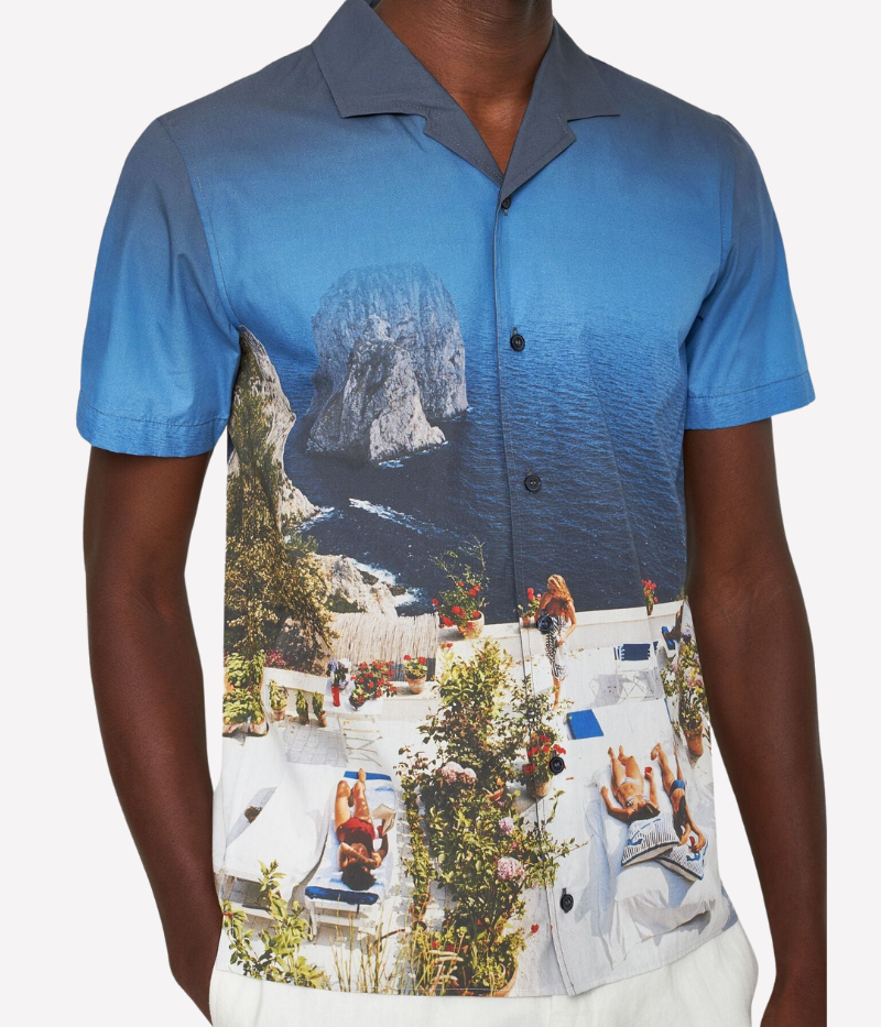 A statement short-sleeve shirt featuring an exclusive Slim Aarons photographic print of sunbathers at Villa Il Canille, a classic fit, Capri collar, and imitation mother-of-pearl buttons.