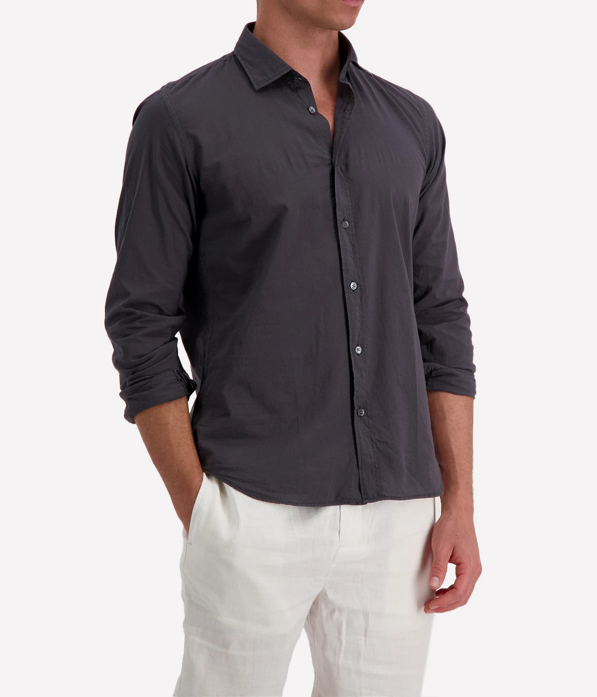 Model wearing the Hartford Sammy Shirt in lightweight cotton voile, featuring a pointed collar and buttoned cuffs. The slim fit creates a flattering, clean silhouette, perfect for casual summer styling.