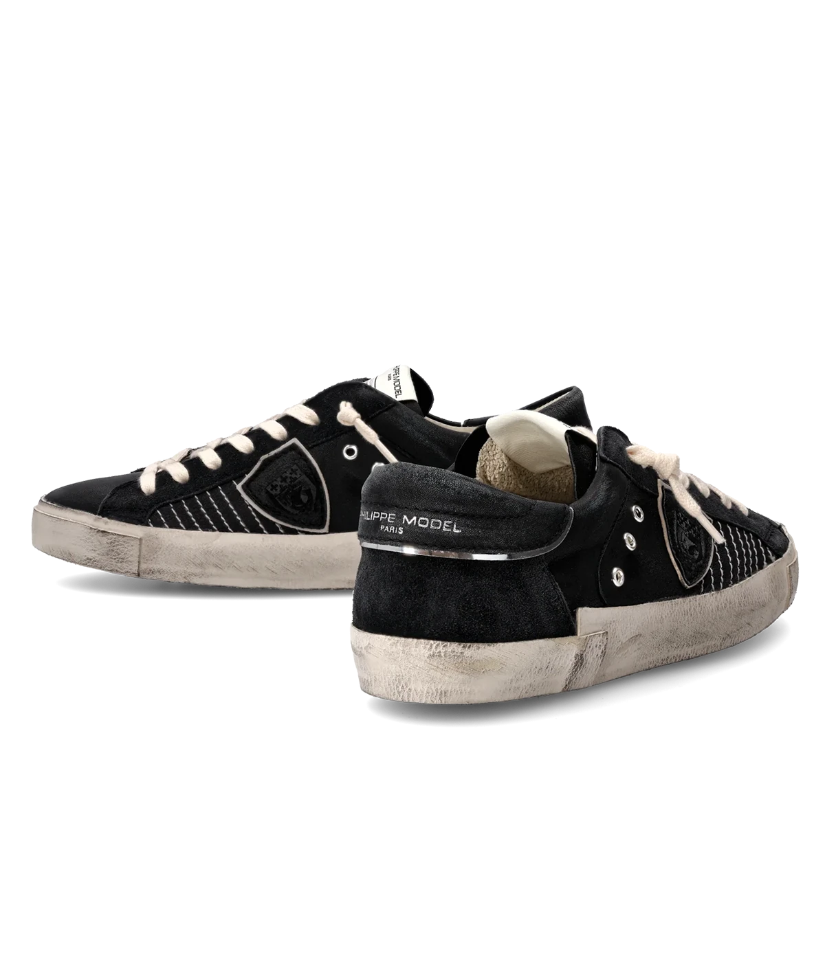 The PRSX sneaker blends ‘80s street style with French Riviera elegance, featuring a black suede and leather upper with contrast stitching, a handcrafted worn-effect sole, and premium comfort details.