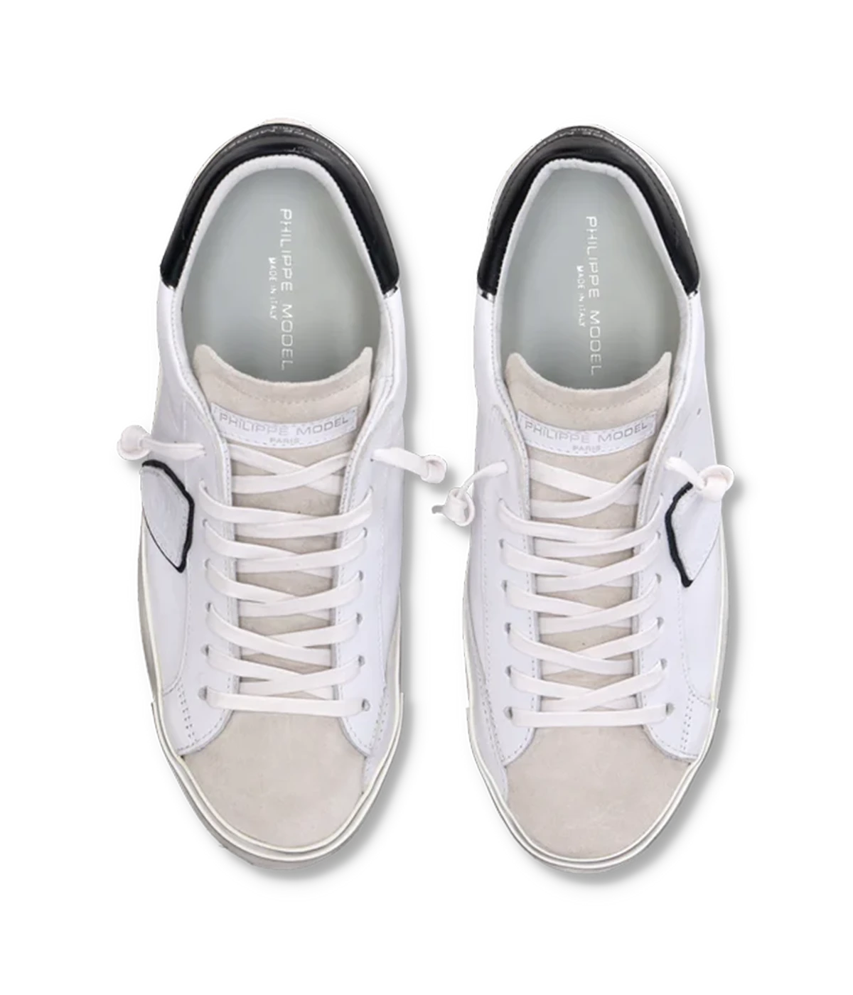 Top view of Philippe Model PRSX Low Man sneakers, highlighting the worn-effect white screen-printed laces and the vintage-used effect on the calfskin and suede upper. The 2.5 cm high brushed rubber sole with a vintage effect is visible.