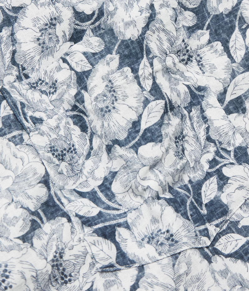 Close-up of the intricate navy and white floral pattern on Hartford's linen-cotton shirt, resembling lace for a refined, elegant look.