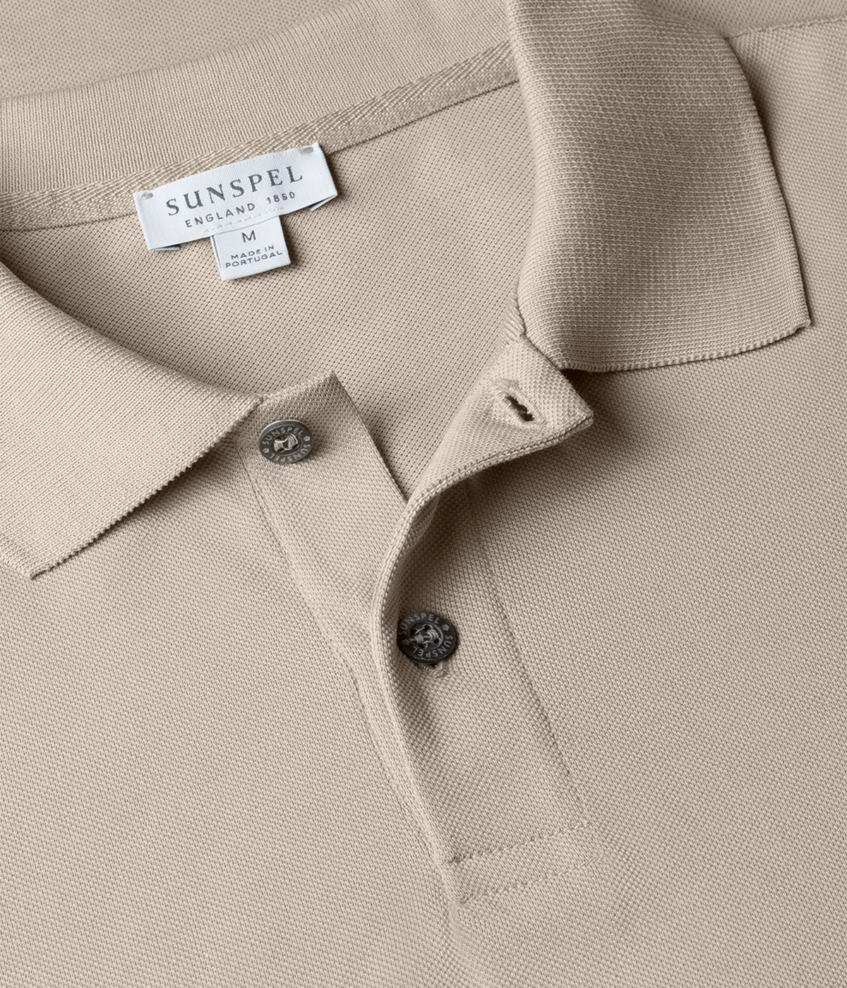 Ash grey piqué polo shirt for men made from Supima cotton. Features ribbed collar, side vents, and branded shell buttons for a sophisticated finish.