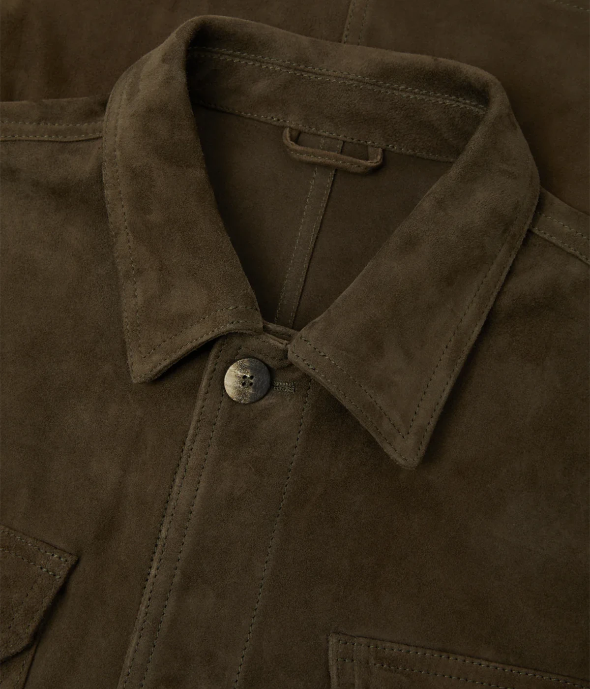 Ravi overshirt in 100% goat suede, featuring a classic collar, front button closure, flap utility pockets, and branded imitation stone buttons. Soft, durable, and crease-resistant with tonal stitching for a polished finish.