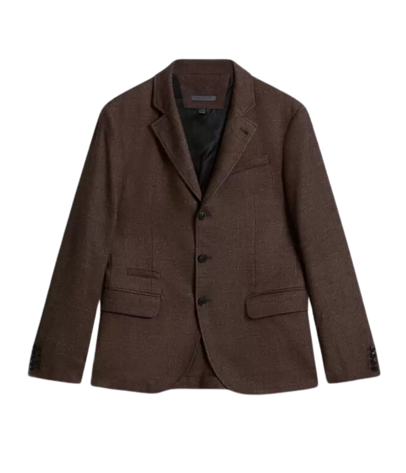 The Rind Jacket in Old Bark blends heritage craftsmanship with modern design, crafted from luxurious Italian goat suede with a rich, earthy tone and distinctive slubbed chine texture. Featuring notch lapels, flap pockets, and a hidden suede accent beneath the collar, this jacket offers timeless sophistication with a contemporary edge, making it a versatile statement piece for any refined wardrobe.