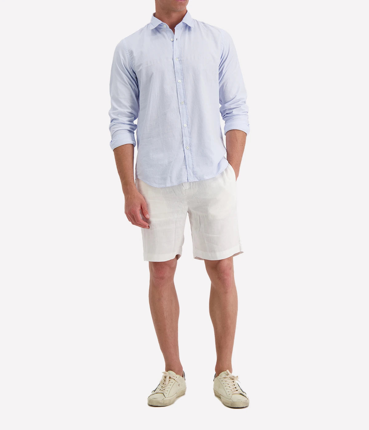 Model wearing the Hartford Sammy Shirt in lightweight cotton voile, featuring a pointed collar and buttoned cuffs. The slim fit creates a flattering, clean silhouette, perfect for casual summer styling.