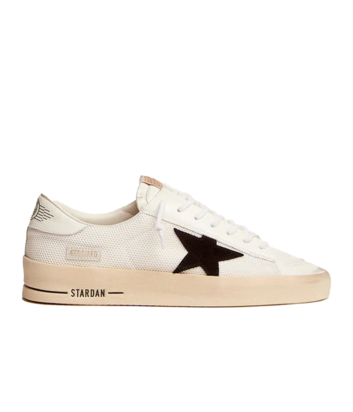 The Golden Goose Stardan Sneaker in White and Black features a sleek netted upper with shiny leather toe and heel details, combining sporty style with luxury craftsmanship. The iconic suede star and durable rubber sole offer comfort and timeless appeal, perfect for both casual and elevated looks.