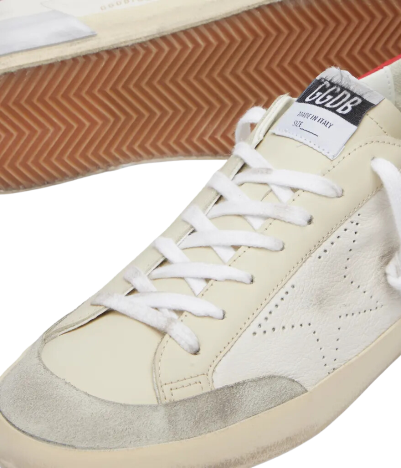 Golden Goose Super-Star Sneaker in red and silver, featuring a signature distressed finish, perforated star detail, and worn-in rubber sole for a vintage-inspired look.