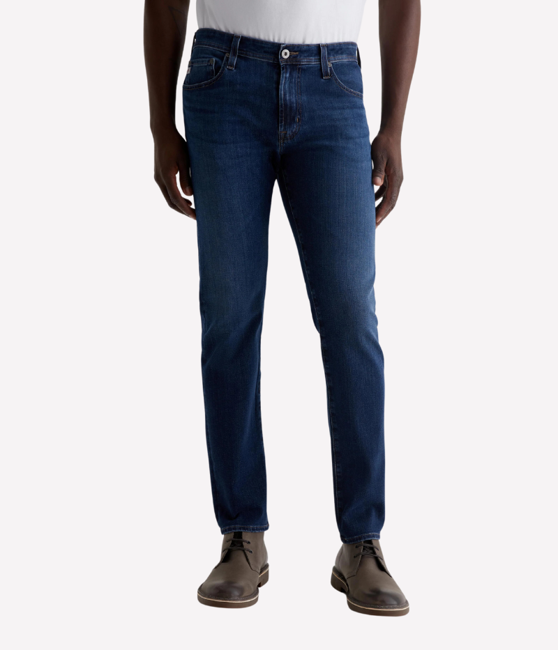 AG Tellis Jean in Matterhorn, slim fit with dark blue wash and subtle fading, featuring a mid-rise waist, fitted upper block, and tapered leg openings, made from 9.5 oz Infinite Bi-Stretch Denim for flexible comfort.