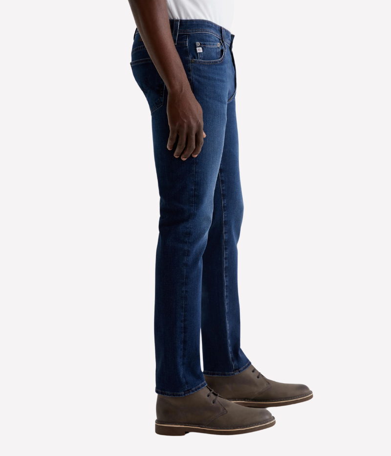 AG Tellis Jean in Matterhorn, slim fit with dark blue wash and subtle fading, featuring a mid-rise waist, fitted upper block, and tapered leg openings, made from 9.5 oz Infinite Bi-Stretch Denim for flexible comfort.