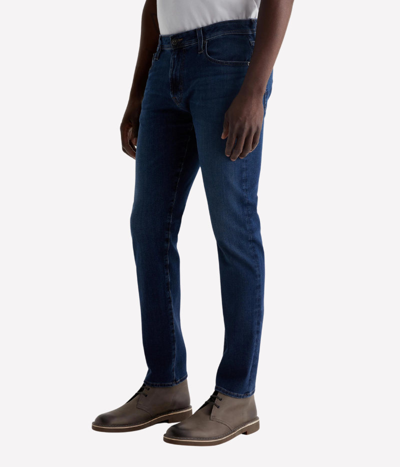 AG Tellis Jean in Matterhorn, slim fit with dark blue wash and subtle fading, featuring a mid-rise waist, fitted upper block, and tapered leg openings, made from 9.5 oz Infinite Bi-Stretch Denim for flexible comfort.