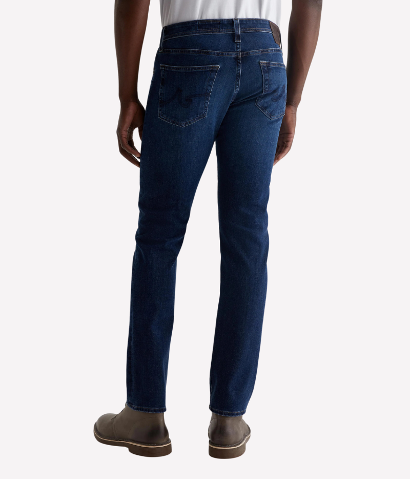 AG Tellis Jean in Matterhorn, slim fit with dark blue wash and subtle fading, featuring a mid-rise waist, fitted upper block, and tapered leg openings, made from 9.5 oz Infinite Bi-Stretch Denim for flexible comfort.