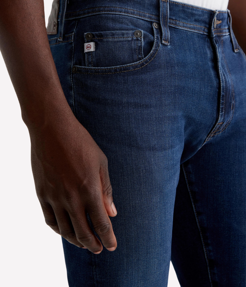 AG Tellis Jean in Matterhorn, slim fit with dark blue wash and subtle fading, featuring a mid-rise waist, fitted upper block, and tapered leg openings, made from 9.5 oz Infinite Bi-Stretch Denim for flexible comfort.