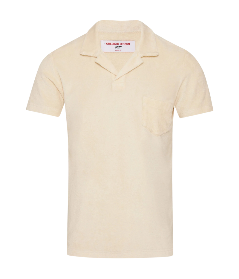 Orlebar Brown Terry Towelling Polo in Latte, inspired by The Man with the Golden Gun. This vintage-inspired polo is made from soft terry towelling cotton, featuring a tailored fit, straight-cut silhouette, and a buttonless placket for effortless sophistication. A perfect blend of comfort and style, ideal for pairing with tailored shorts or dressing up for an evening out.