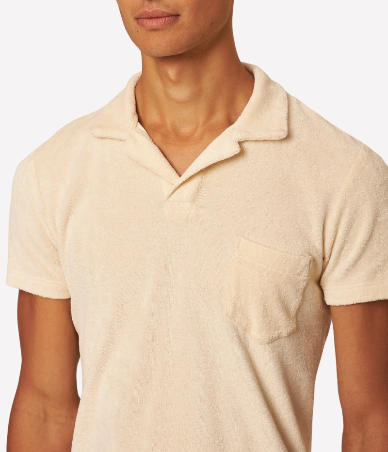 Orlebar Brown Terry Towelling Polo in Latte, inspired by The Man with the Golden Gun. This vintage-inspired polo is made from soft terry towelling cotton, featuring a tailored fit, straight-cut silhouette, and a buttonless placket for effortless sophistication. A perfect blend of comfort and style, ideal for pairing with tailored shorts or dressing up for an evening out.